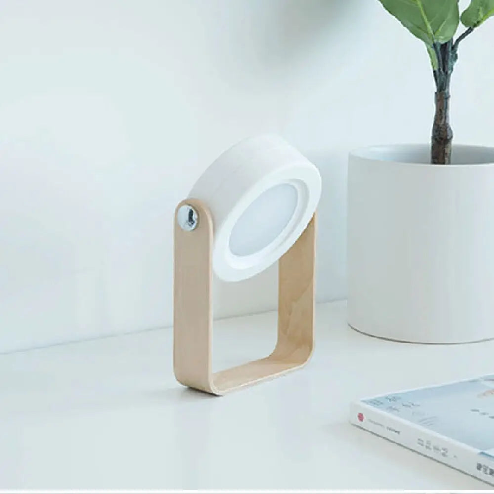 Minimalist white led battery-operated wall sconce lantern with a light wood base and adjustable head design