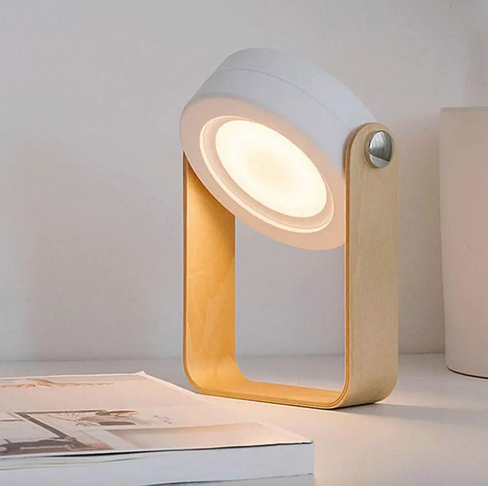 Minimalist white and light wood battery-operated wall sconce lantern with circular glowing led head on wooden frame