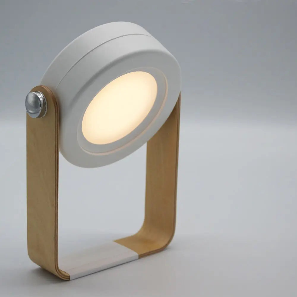 Minimalist white and light wood battery-operated wall sconce lantern with circular illuminated head and modern design