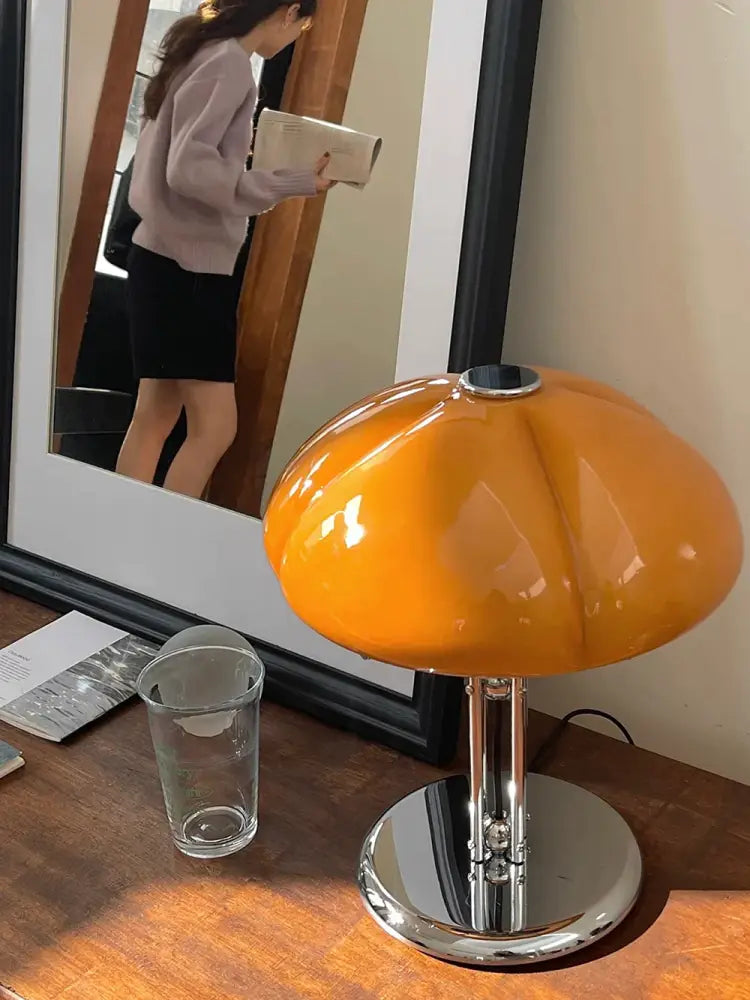 Vibrant orange bauhaus medieval table lamp with amber glass acrylic shade and polished chrome base for bedroom atmosphere