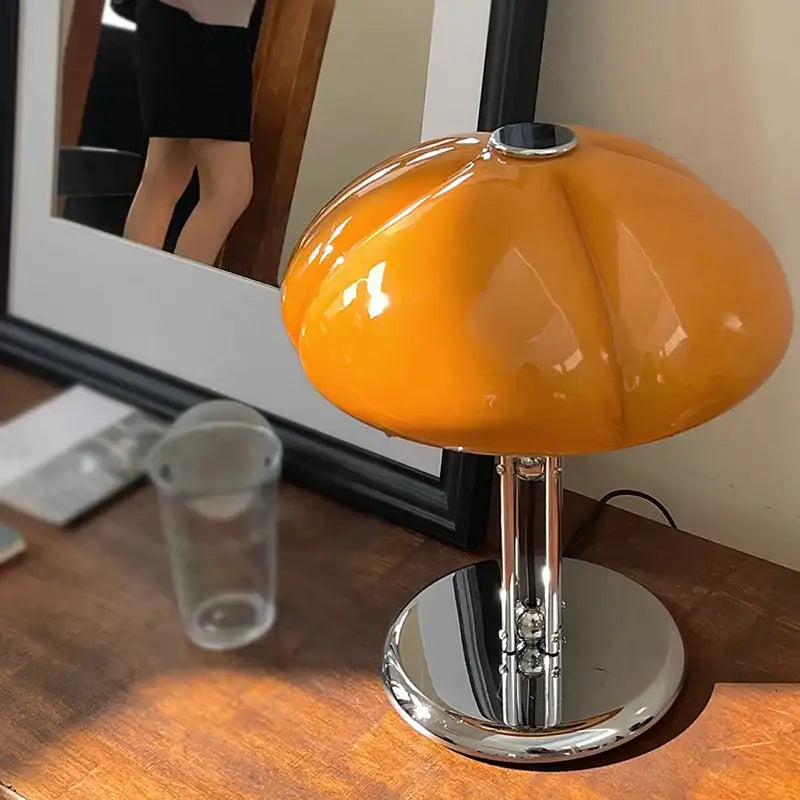 Vibrant orange glossy bauhaus medieval table lamp with amber glass and chrome base for bedroom atmosphere