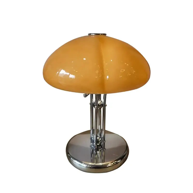 A bauhaus medieval table lamp with an amber glass shade and polished chrome base for bedroom atmosphere