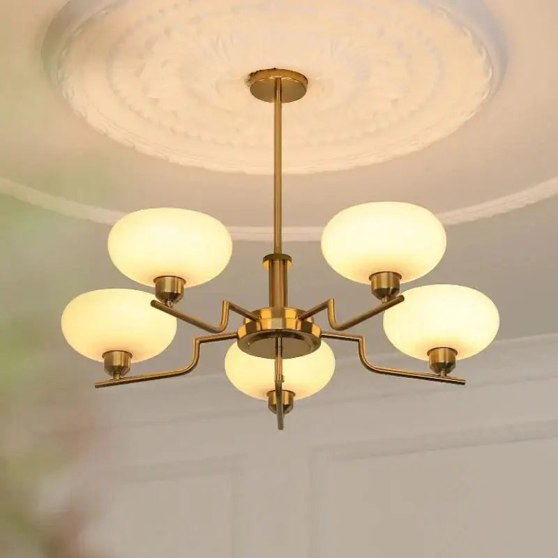 Bauhaus glass pendant chandelier with brass finish and five frosted glass globe shades for dining room lighting