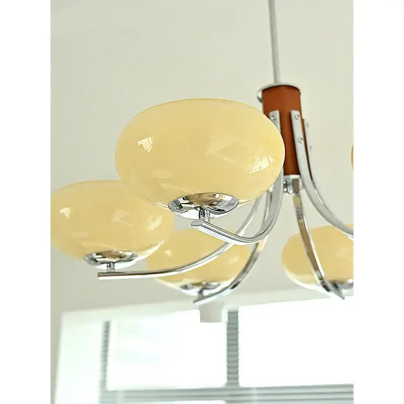 Cream-colored opal glass globe glass chandelier with chrome arms and wooden column for bauhaus art living room design