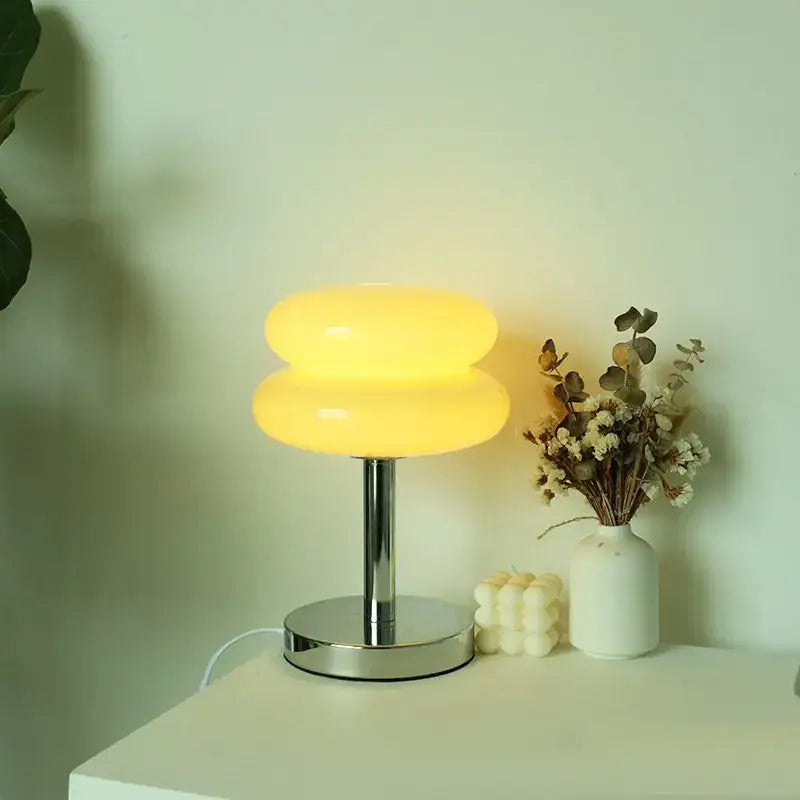 Bauhaus glass table lamp with a warm yellow translucent glass shade and sleek chrome base for bedroom lighting