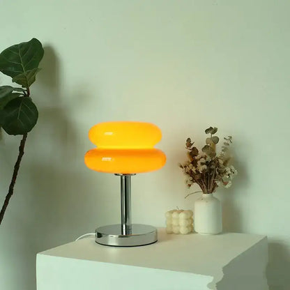 Vibrant orange two-tiered bauhaus glass table lamp with sleek chrome base for bedroom lighting