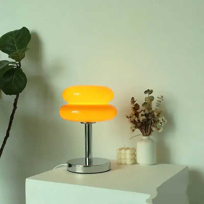 Vibrant orange two-tiered bauhaus glass table lamp with sleek chrome base for bedroom lighting