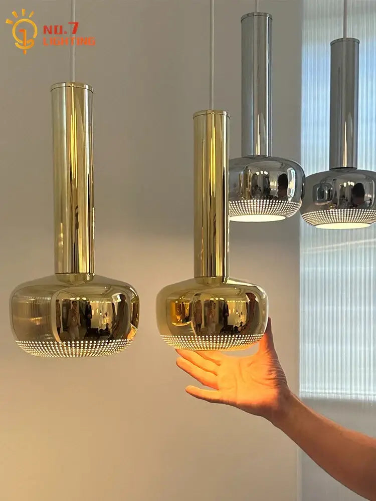 Bauhaus copper chrome pendant lights with gold and chrome cylindrical design and reflective dotted base for kitchen island