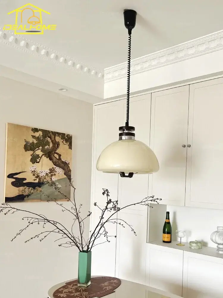 Bauhaus cream glass pendant light with cream-colored dome, black coiled chain, and metallic accents for kitchen decorbites pendant lights