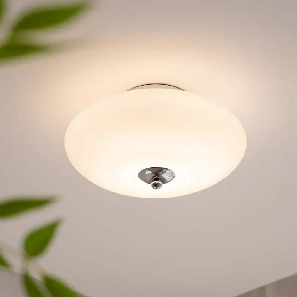 A modern bauhaus cream white glass ceiling lamp with frosted shade and polished chrome fixture for dining room decorbites