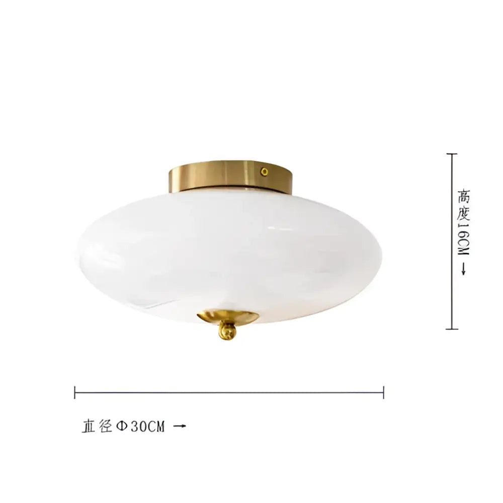 A sleek cream white glass ceiling lamp with brass-finished metal base perfect for dining room decorbites cream white