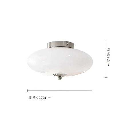 A sleek decorbites cream white ceiling lamp with cream white glass and brushed metal fixture for dining room lighting