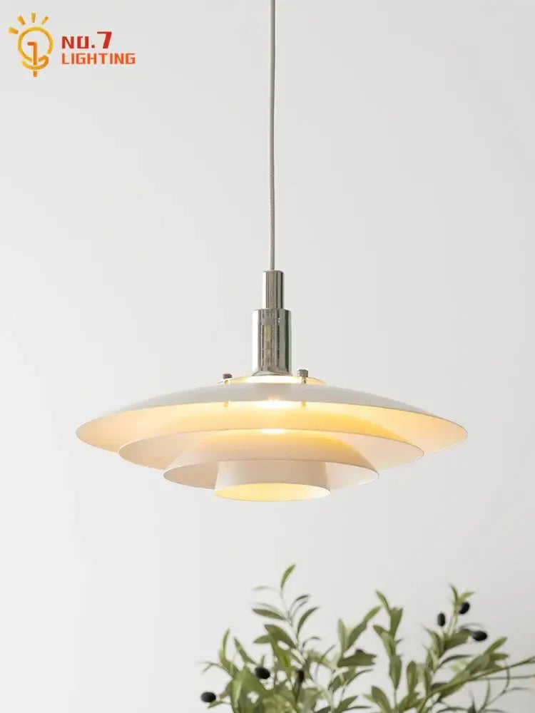 Modern bauhaus flying saucer pendant light with tiered white ceramic shade and polished chrome hardware for dining room use