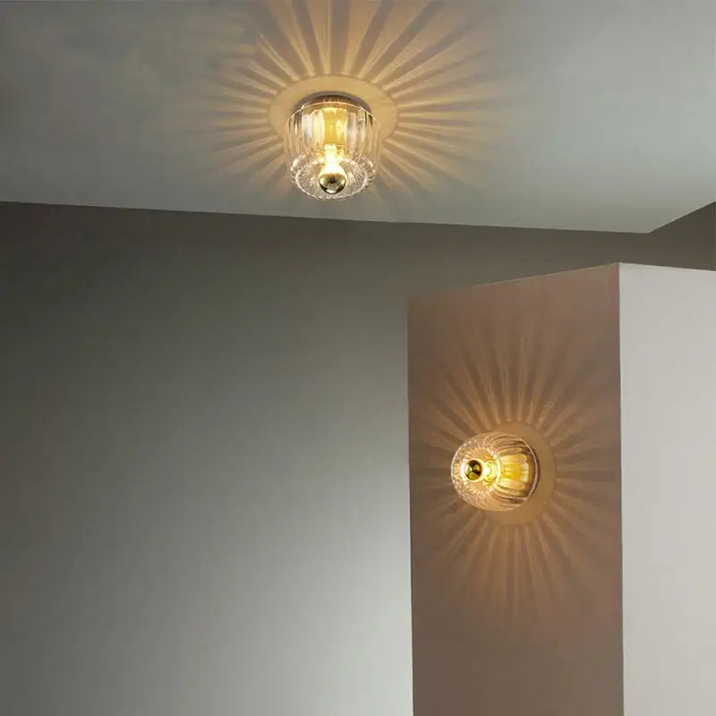 Bauhaus glass e14 wall lamp with clear ribbed glass ceiling and gold-toned metallic sunburst base for living room