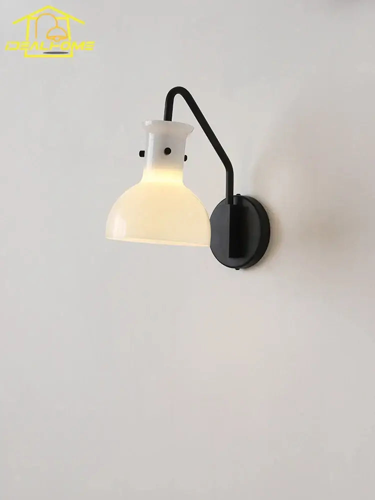 Black metal bauhaus glass led wall lamp with frosted glass lampshade emitting warm light for bedroom sconce