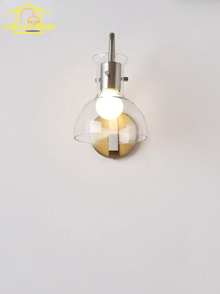 Modern bauhaus glass led wall lamp with clear glass globe and gold accented black metal sconce for bedroom lighting