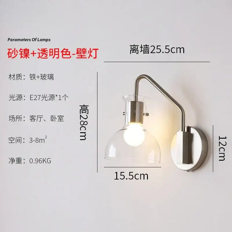 A sleek bauhaus glass led wall lamp with black metal sconce and clear glass shade for modern bedroom lighting
