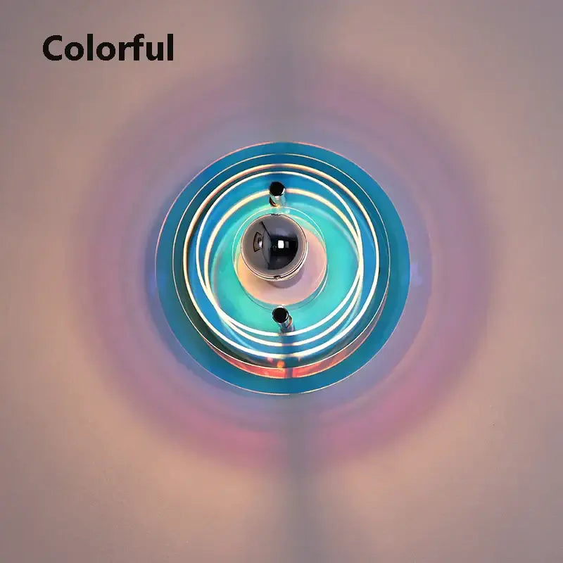 Vibrant bauhaus led wall sconces featuring concentric blue and teal glass rings with a central reflective sphere