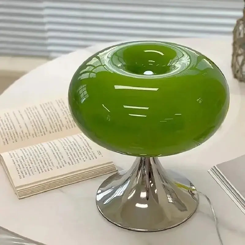 Vibrant green glossy bauhaus led table lamp with a sleek chrome pedestal base for living room use