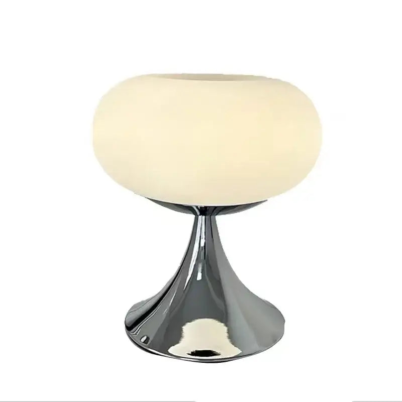 Cream-colored frosted glass led table lamp with sleek chrome finished metallic base for living room use