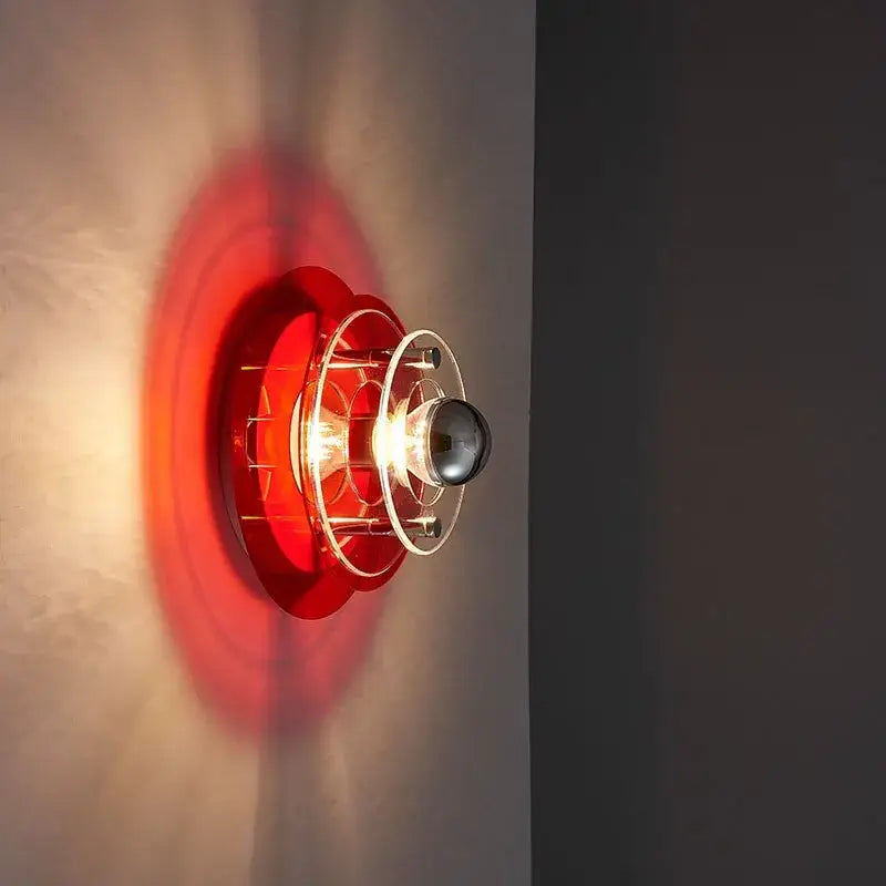 Red circular bauhaus modern acrylic ufo led wall lamp with clear glass cage and metallic accents for living room decorbites led wall