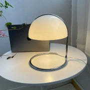 A sleek bauhaus mushroom modern led desk lamp with white opal glass dome and polished chrome frame for bedroom aromatherapy