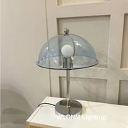 A bauhaus mushroom table lamp with chrome finish and transparent blue dome for bedroom night light