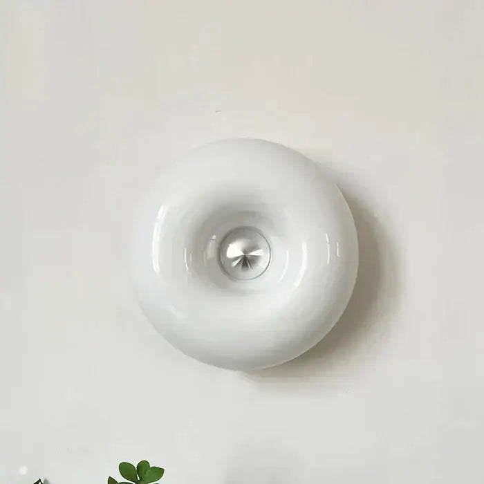 White ceramic wall lamp with glossy finish and central metallic accent decorbites donut wall lamp for bedroom light