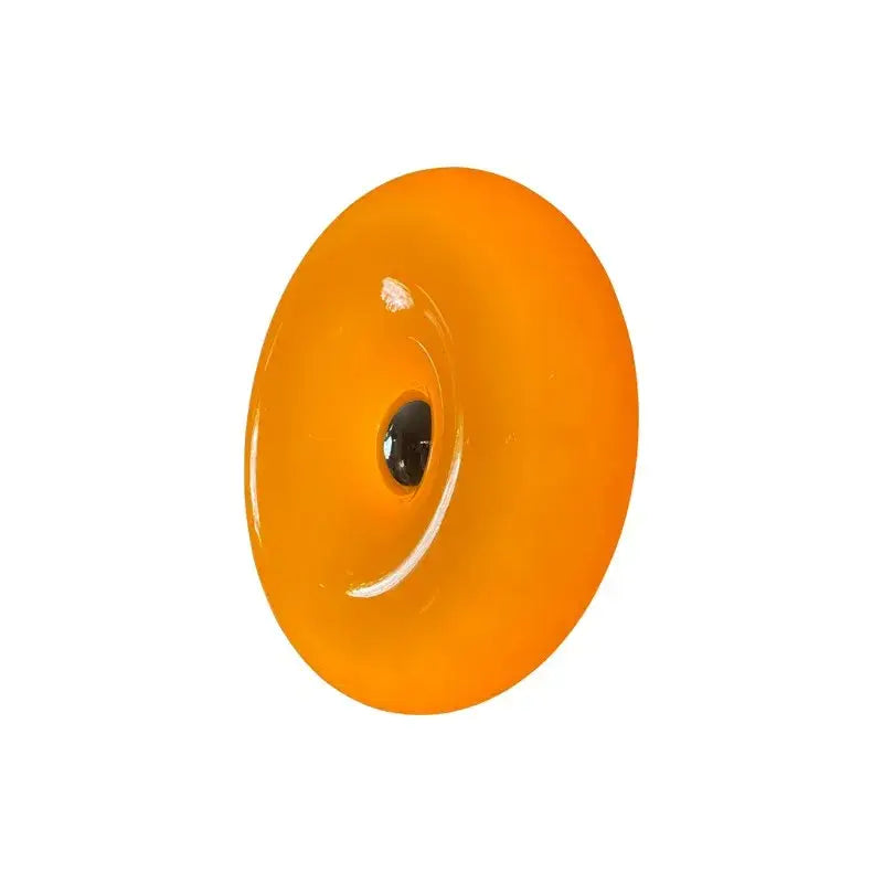 Vibrant orange glossy glass decorbites donut wall lamp with central black hole for bedroom atmosphere light