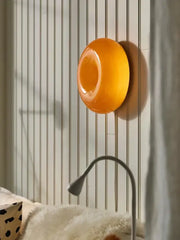 Vibrant orange glossy circular decorbites donut wall lamp with smooth modern design for bedroom atmosphere light