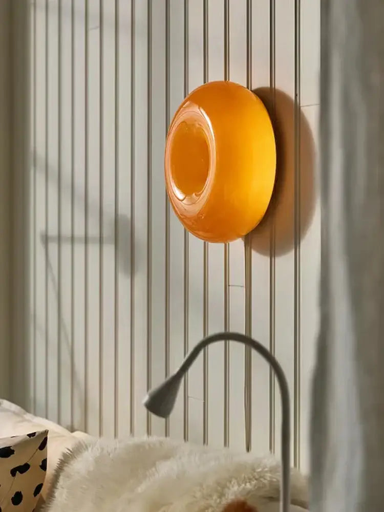 Vibrant orange glossy circular decorbites donut wall lamp with smooth modern design for bedroom atmosphere light