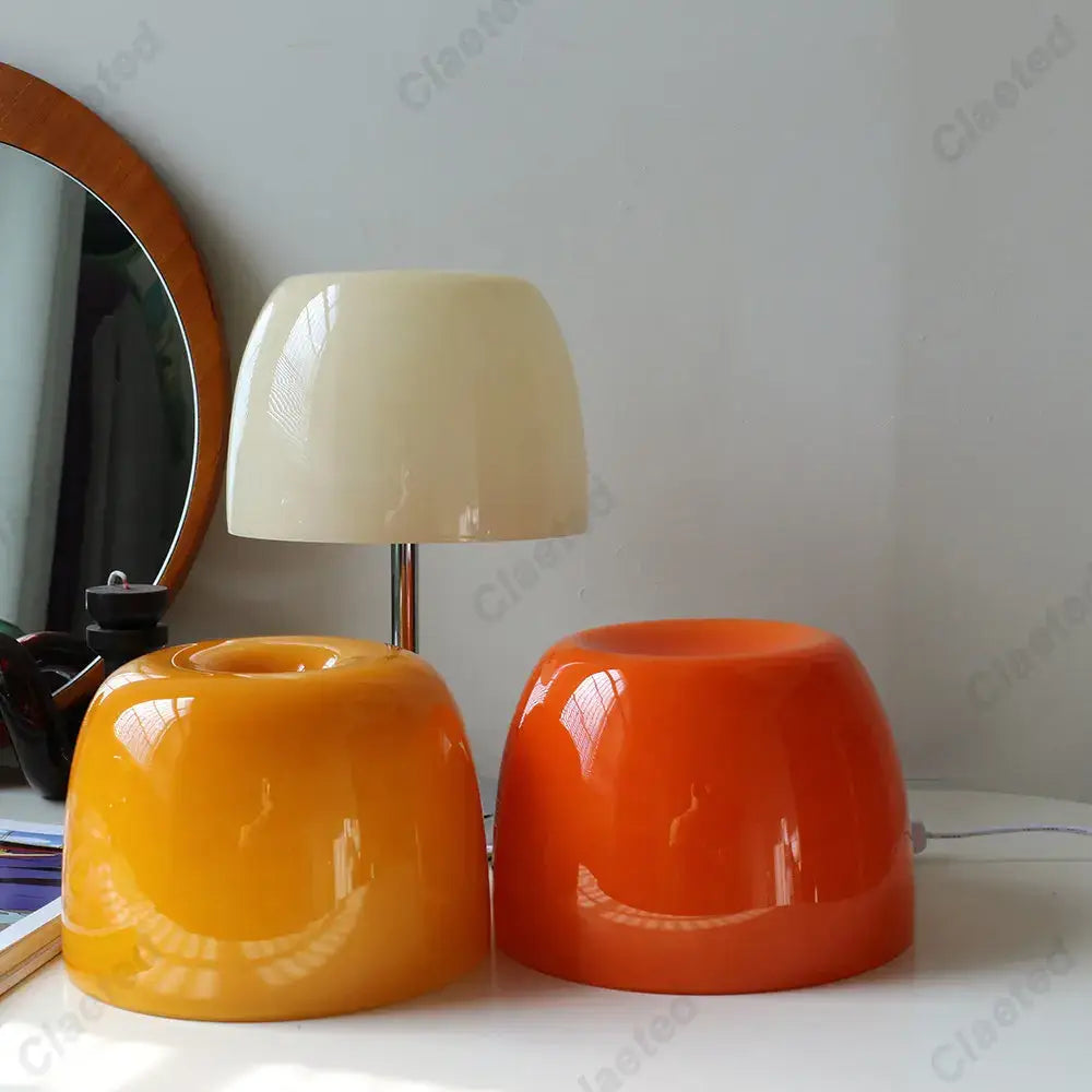 Cream-colored glass lampshade with sleek modern design on bauhaus retro table lamp with chrome base for bedroom use