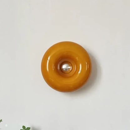 Glossy amber bauhaus orange glass table lamp with central metallic accent for bedroom desk lighting