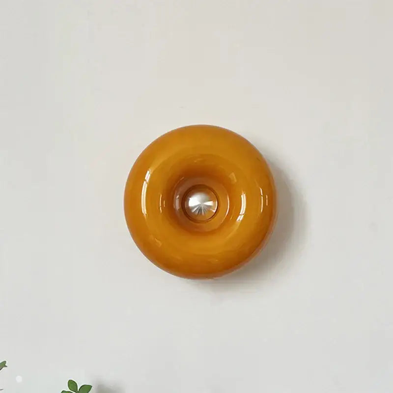 Glossy amber bauhaus orange glass table lamp with central metallic accent for bedroom desk lighting