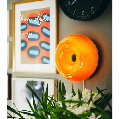 Vibrant bauhaus orange glass table lamp with glossy circular design ideal for bedroom donut desk lighting