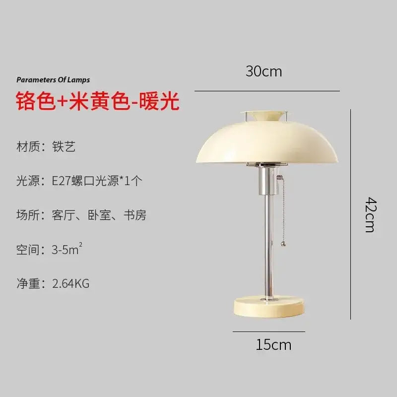 Cream-colored dome-shaped lampshade with chrome base on a bauhaus led table lamp for bedroom use