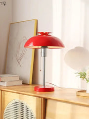 Vibrant red glossy ceramic bauhaus led table lamp with sleek chrome stem and base ideal for bedroom use