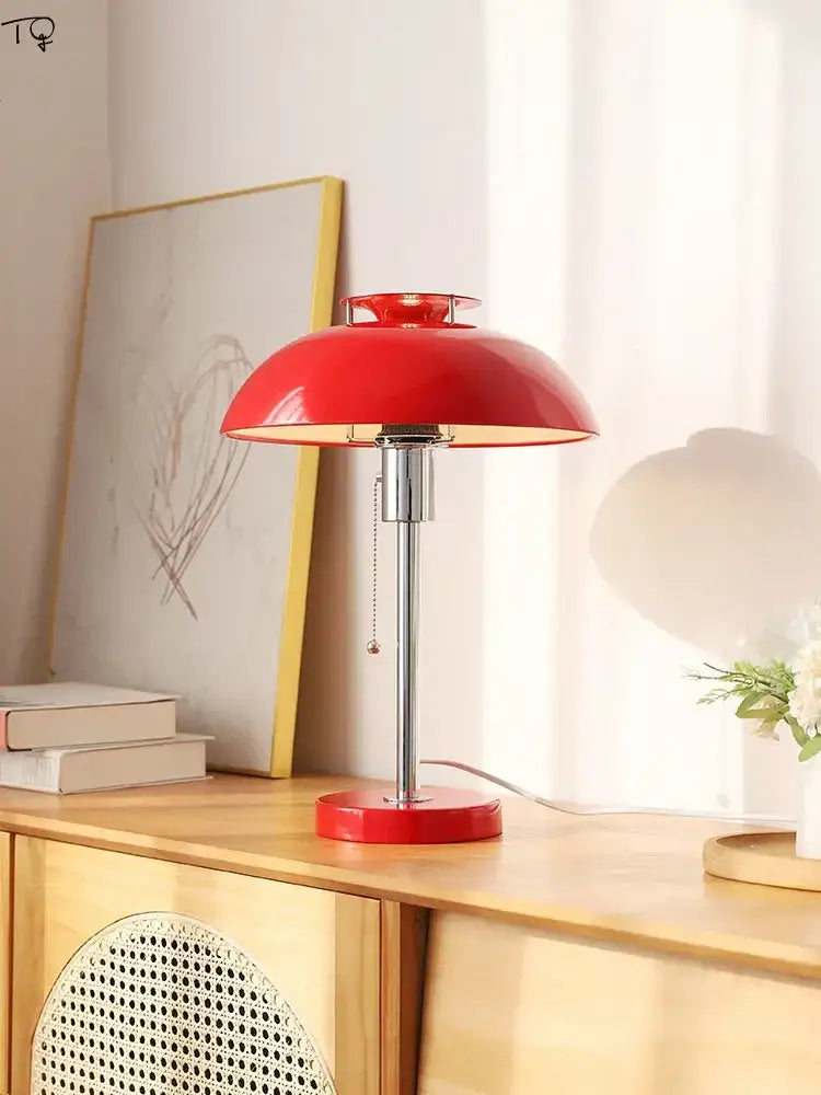 Vibrant red glossy ceramic bauhaus led table lamp with sleek chrome stem and base ideal for bedroom use