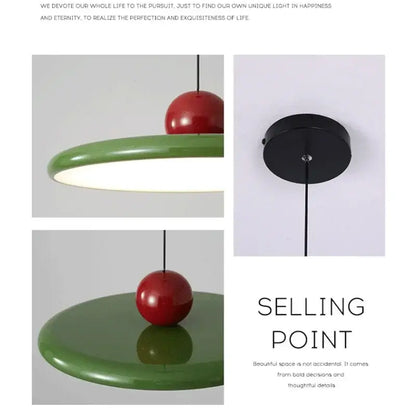 Modern bauhaus saucer chandelier pendant light featuring a glossy red spherical top and matte green circular base for dining room