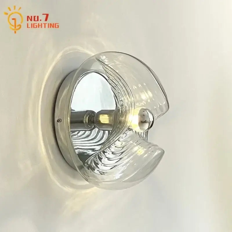 Clear sculpted bauhaus wavy glass wall lamp with chrome base and filament bulb for bedroom lighting