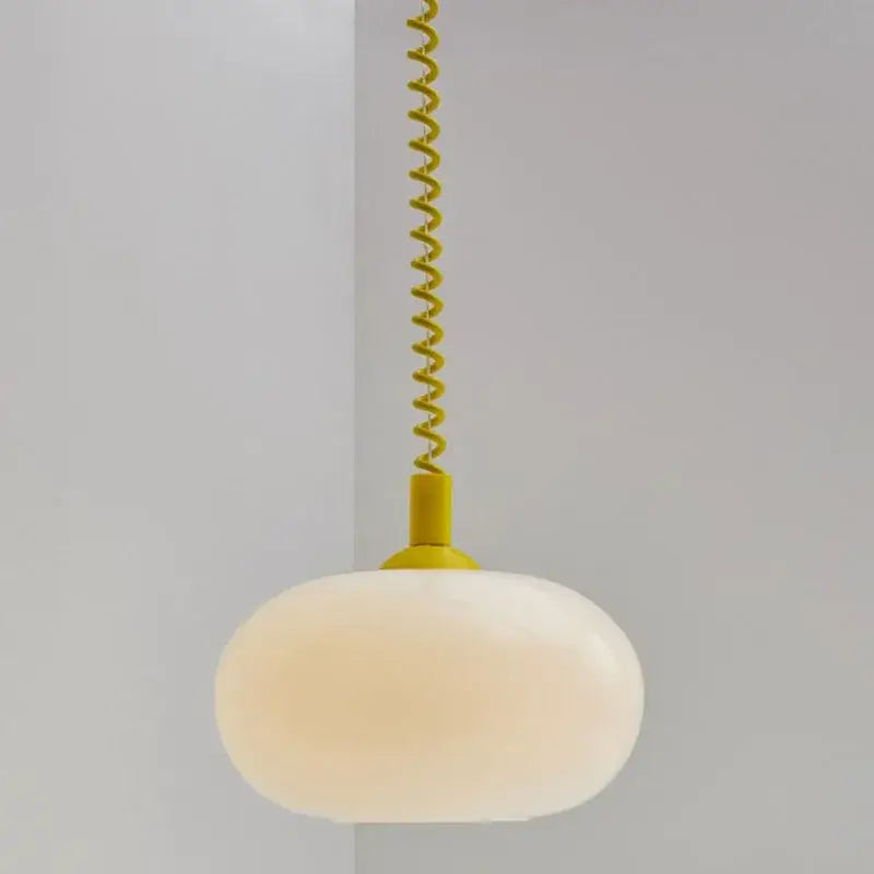 Bauhaus glass pendant light with matte yellow spiral cord and frosted white oval shade for dining room lighting