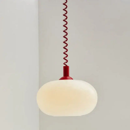 Bauhaus glass pendant light with a frosted white globe and vibrant red spiral cord for dining room lighting
