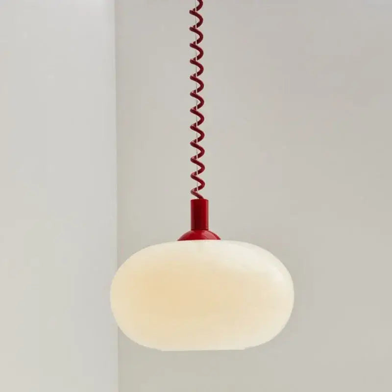 Bauhaus glass pendant light with a frosted white globe and vibrant red spiral cord for dining room lighting