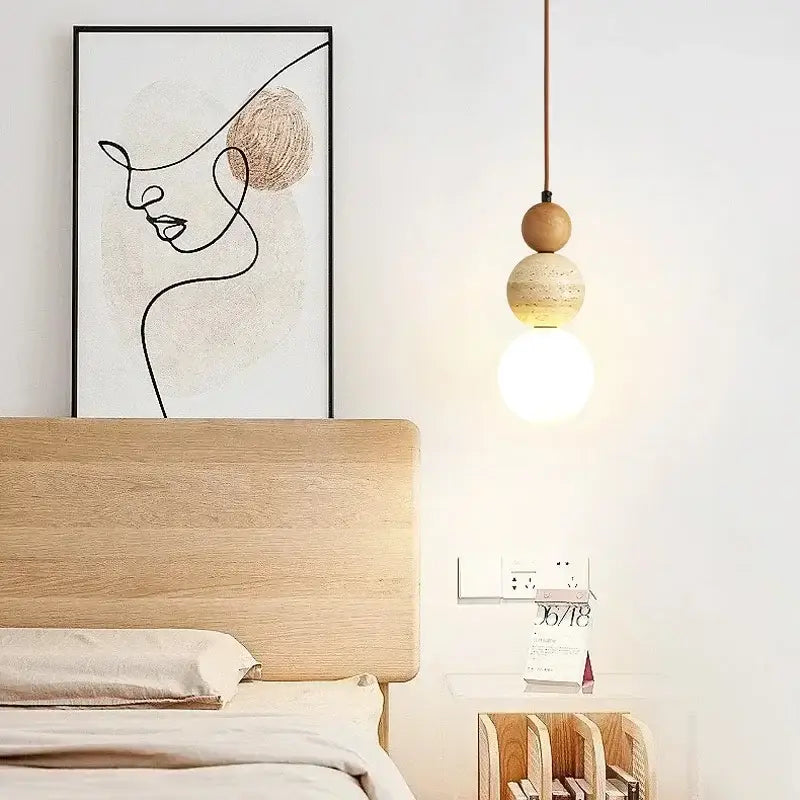 Minimalist bauhaus pendant light with stacked wood and beige stone spheres featuring an led bulb and cord pendant