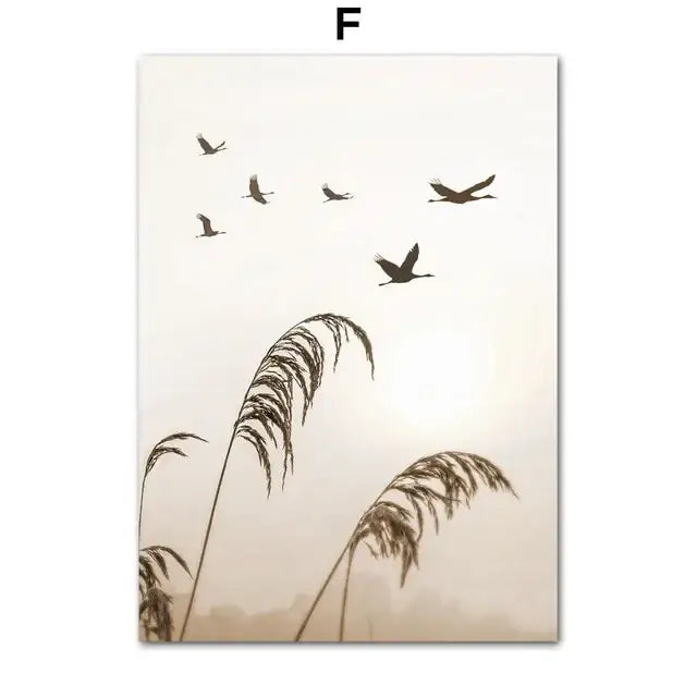 Silhouetted birds in flight above tall reeds on a soft beige canvas wall art for bohemia beach home decor by decorbites
