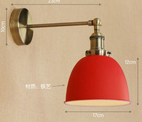 Red dome-shaped wall lamp with brass accents and adjustable arm, iron construction.