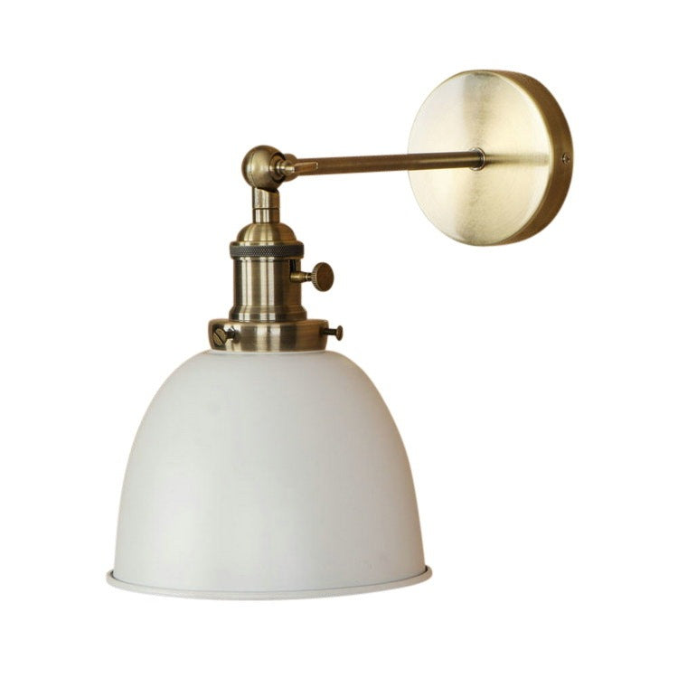 Brass and white industrial-style wall sconce with adjustable arm.