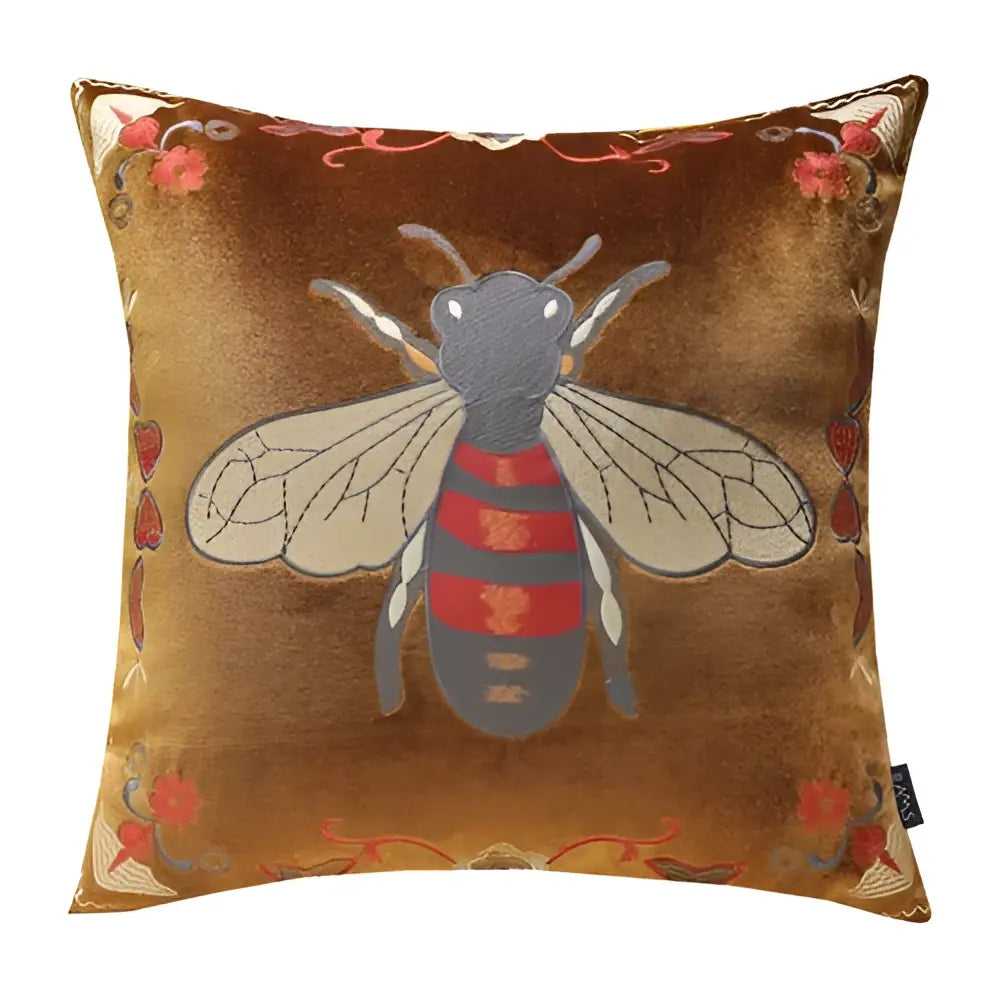 A golden-brown velvet cushion cover with detailed bee embroidery in black, red stripes, perfect for living room decor