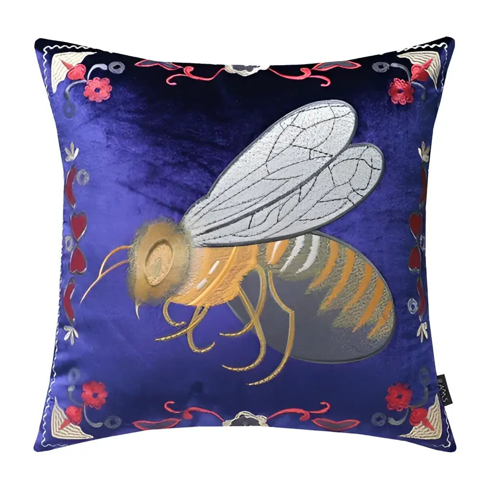 A navy blue velvet cushion cover with intricate bee embroidery and floral motifs for living room decor