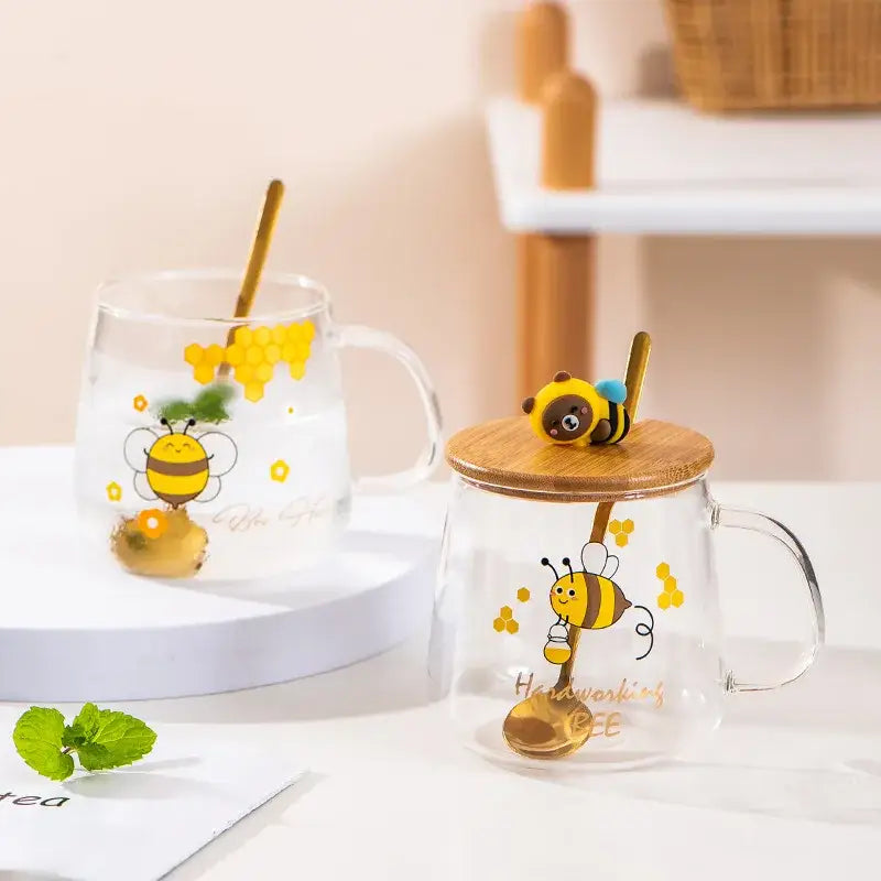 Bee glass spoon milk cup featuring a clear glass mug with bamboo lid and golden bee-shaped spoon with honeycomb design